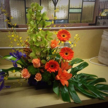 Orange gerbera and orchid arrangement